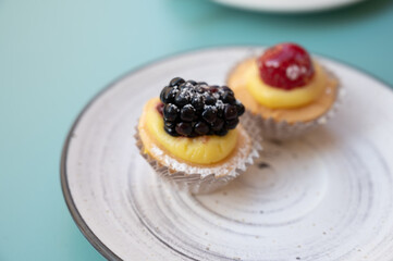 Mini fruit italian cupcakes with fresh berries on board