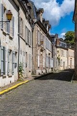 Senlis, medieval city in France, typical cobblestone street with ancient houses
