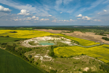 ariel top view of an old flooded lime quarry with turquoise water - obrazy, fototapety, plakaty