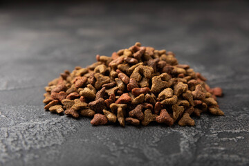 Dry food for cats on a cement background. Vitamins and nutrients for good health and energy of pets.Copy space.