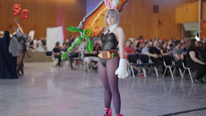 Battle Bunny Riven cosplay character girl from game pose at comic con