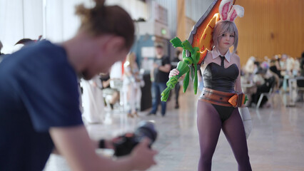 Videographer shooting Battle Bunny Riven cosplay girl on comic con