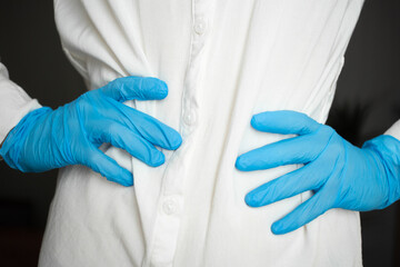 Blue medical gloves at the waist