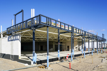 A new modern store building steel and concrete frame is under construction