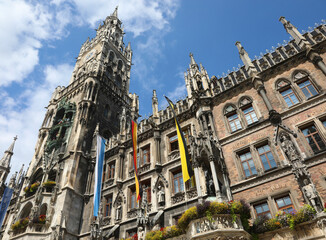 Clock tower of the Town Hall of Munich in Germany and the flags
