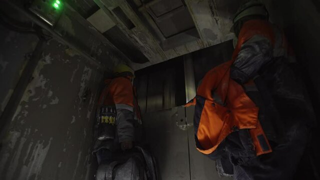 The miners go down the elevator into the mine. Underground development, underground mining, underground mining.