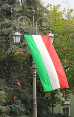Italian flag on the street lamps of the city