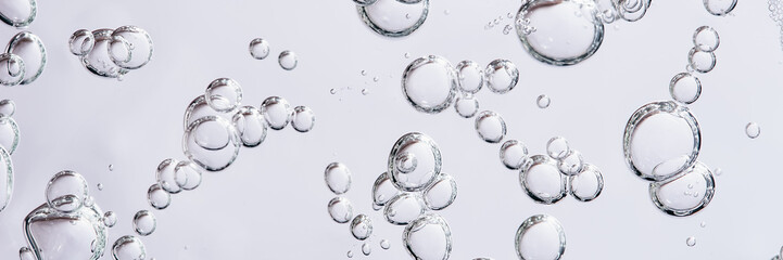 Close up macro Aloe vera gel serum cosmetic texture blue background with bubbles. Cruelty free....