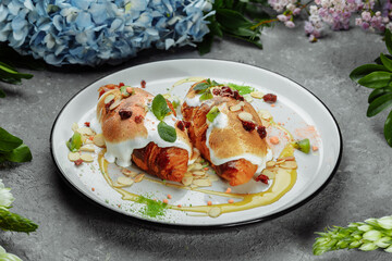croissant with sweet cream and almonds on a plate. Delicious and healthy breakfast