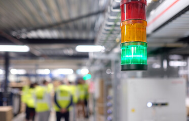 Selective focus on a green light in a manufacturing factory