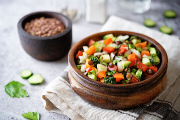 Lentil red bell pepper cucumber salad in a bowl