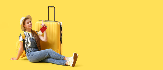 Female traveler with suitcase on yellow background. Banner for design
