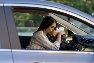 Depressed young woman driver sitting inside car, feeling doubtful confused about difficult decision suffering from personal psychological problem, burnout, quarrel break up with boyfriend, life crisis