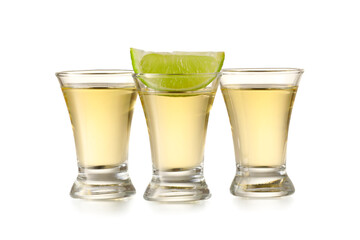 Shots of tasty mexican tequila with lime on white background