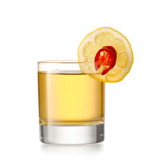 Glass of tasty mexican tequila with lemon on white background