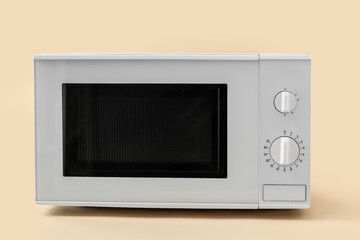 Fototapeta premium New modern microwave oven on color background