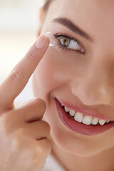 Contact Eye Lens. Smiling Woman Applying Eye Contacts on her Eyes Closeup. Girl with Natural Face...