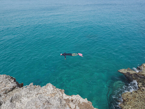 One Man Swimming Snorkeling In Clean Water In Ocean. View From Above.