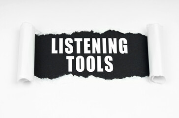 In the middle of the white sheet is a black frame with the inscription - Listening Tools
