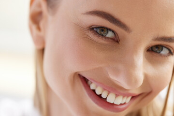 Woman Smile. Closeup Of Beautiful Happy Girl With Perfect Smile, White Teeth Smiling At Camera. Attractive Healthy Young Female With Fresh Natural Face Makeup Indoors. Dental Care Concept