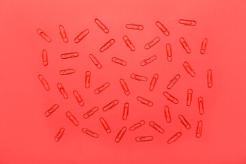 Paper clips on red background