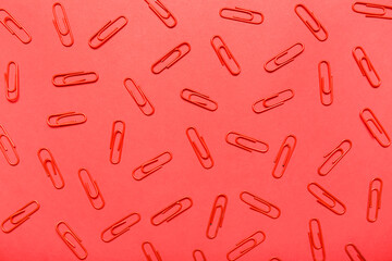 Paper clips on red background