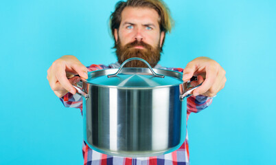 Bearded man with saucepan or pot. Food preparation. Kitchenware. Cooking utensils advertising.