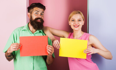 Smiling couple with empty advertising boards. Season Sale. Discount. Message board with copy space.