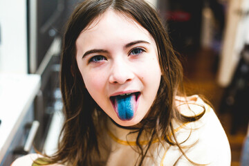 Girl with blue tongue from eating candy