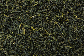 Chinese green leaf tea. Dried tea leaves background, top view