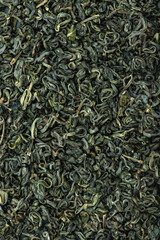 Chinese green leaf tea. Dried tea leaves background, top view