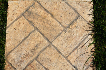 Tile texture with orange and cream coloring. Top view.