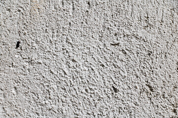 White wall texture with reliefs. Closeup. White background