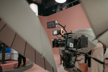 Professional film and video camera on the set. Shooting shift, equipment and group.