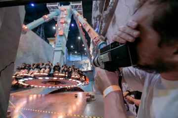 Director of photography with a camera in his hands on the set. Professional videographer at work on filming a movie