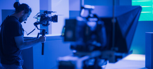 Director of photography with a camera in his hands on the set. Professional videographer at work on...