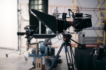 A professional film and video camera on the set. Filming day, equipment and crew. Technique of modern video filming.