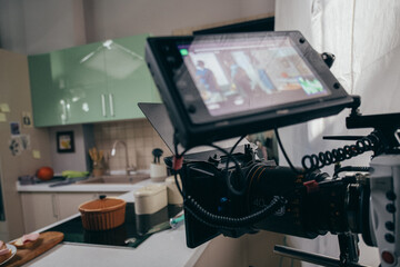 Professional film and video camera on the set. Shooting shift, equipment and group.