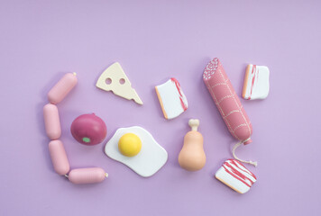 Children's wooden eco-friendly handmade toys. Imitation of products. Bread, sausages, fried eggs. Top view