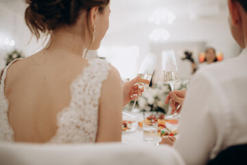 beautiful bride and groom sitting on a table with a wedding rings