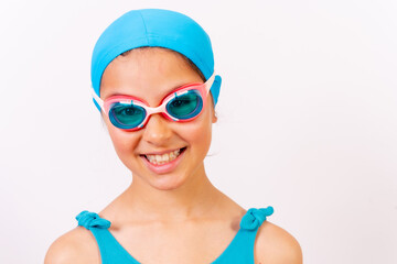 Portrait of girl with swimsuit and diving goggles for swimming lessons in the pool in summer. White background