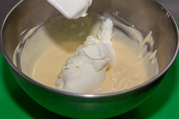 whisking egg yolks and sugar in a bowl