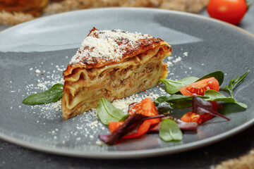 Homemade delicious Meat lasagna with basil leaf on the top. Close up. Recipe, menu. Italian cuisine. Side view