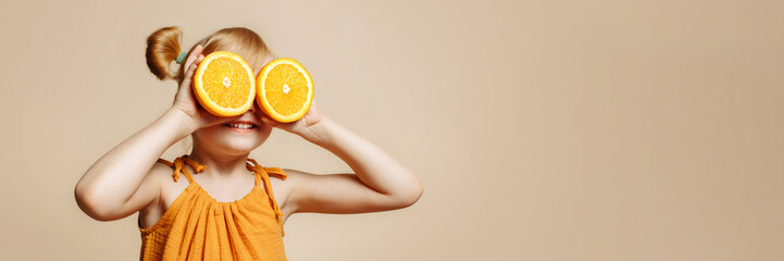 Banner girl holding oranges in front of her face