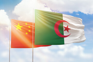 Sunny blue sky and flags of algeria and china