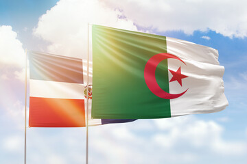 Sunny blue sky and flags of algeria and dominican republic