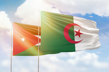 Sunny blue sky and flags of algeria and jordan