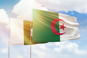 Sunny blue sky and flags of algeria and pakistan