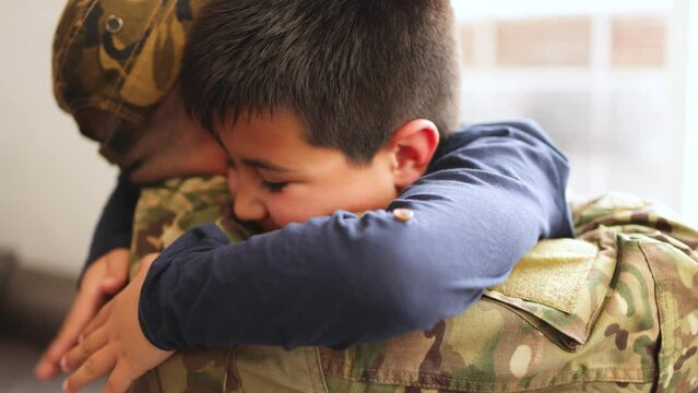 Military soldier father with son kid smiling on camera during home return - Family love US army