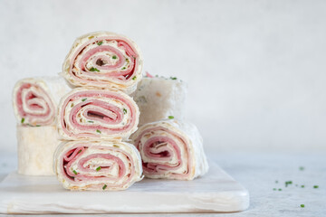 Ham and cream cheese rolled up in a flour tortilla